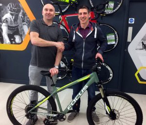 Love to Ride cyclist Ross Hall from Plusnet (right) receives his prize Focus Whistler mountain bike from Stephen Allen at JE James Cycles